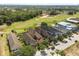 Aerial view of homes located adjacent to a golf course with mature trees and landscaping at 781 Golden Bear Dr, Kissimmee, FL 34747
