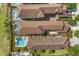 Aerial view of multiple homes with swimming pools, patios, well-kept lawns, and lush landscaping at 781 Golden Bear Dr, Kissimmee, FL 34747