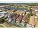 Aerial view of houses with swimming pools, patios, and landscaping near a picturesque lake at 781 Golden Bear Dr, Kissimmee, FL 34747