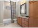 Bathroom featuring a framed mirror, bath tub and shower combination with a patterned shower curtain at 781 Golden Bear Dr, Kissimmee, FL 34747
