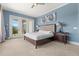 Comfortable bedroom with a plush bed, soft lighting, and balcony access at 781 Golden Bear Dr, Kissimmee, FL 34747