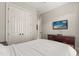 Bedroom featuring a white bedspread, a television and double doors to a closet at 781 Golden Bear Dr, Kissimmee, FL 34747