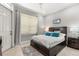Bedroom with large window, neutral walls, and a comfortable bed with blue decorative pillows at 781 Golden Bear Dr, Kissimmee, FL 34747