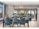 Dining room area featuring modern lighting and large windows overlooking the patio at 781 Golden Bear Dr, Kissimmee, FL 34747