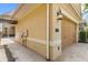 Exterior view of a home featuring tan stucco and a beige two-car garage at 781 Golden Bear Dr, Kissimmee, FL 34747