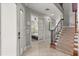 Bright entryway featuring a staircase, tiled floors, and an open doorway leading to the bedroom at 781 Golden Bear Dr, Kissimmee, FL 34747