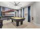 Upstairs game room with a pool table, large windows, and modern decor at 781 Golden Bear Dr, Kissimmee, FL 34747