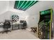 Fun game room with arcade game, work space, and a unique neon light fixture at 781 Golden Bear Dr, Kissimmee, FL 34747