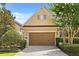 Charming home featuring a two-car garage, neat landscaping, and a brick driveway at 781 Golden Bear Dr, Kissimmee, FL 34747