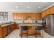 Modern kitchen featuring stainless steel appliances, granite countertops, and wooden cabinets at 781 Golden Bear Dr, Kissimmee, FL 34747