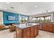 Open-concept kitchen featuring an island with sink and adjacent living room with large windows at 781 Golden Bear Dr, Kissimmee, FL 34747