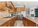 Modern kitchen featuring stainless steel appliances, granite countertops, and wooden cabinets at 781 Golden Bear Dr, Kissimmee, FL 34747