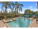 Backyard featuring a private pool, spa, and lounge area surrounded by tropical landscaping at 781 Golden Bear Dr, Kissimmee, FL 34747