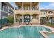 Backyard swimming pool with patio, outdoor seating, and a two-story home with balconies at 781 Golden Bear Dr, Kissimmee, FL 34747