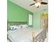 Bedroom with comfortable bed, ensuite bathroom, and plush carpeting with a ceiling fan overhead at 847 Orista Dr, Davenport, FL 33897
