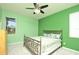 Comfortable bedroom with a metal bed frame, neutral paint, and plush carpeting, and view to exterior at 847 Orista Dr, Davenport, FL 33897