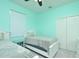 Cozy bedroom with two twin beds features mint walls, carpet, and a closet with double doors at 847 Orista Dr, Davenport, FL 33897
