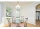 Bright dining area showcasing a glass table, decorative chairs, and three large windows at 847 Orista Dr, Davenport, FL 33897