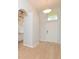 Inviting foyer with hardwood floors features a decorative light fixture and a sidelight window at 847 Orista Dr, Davenport, FL 33897
