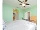 Spacious main bedroom features mint walls, ceiling fan, and access to the bathroom and closet at 847 Orista Dr, Davenport, FL 33897