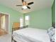 Bright main bedroom features mint walls, ceiling fan, a window, and a chest of drawers at 847 Orista Dr, Davenport, FL 33897