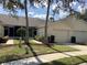 Charming villa with a well-maintained lawn, tidy landscaping, and an attached one-car garage at 88 Club Villas Ln, Kissimmee, FL 34744