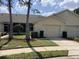 Charming villa with a well-maintained lawn, tidy landscaping, and an attached one-car garage at 88 Club Villas Ln, Kissimmee, FL 34744