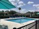 The community pool area has comfortable seating and umbrellas for relaxation in a welcoming environment at 88 Club Villas Ln, Kissimmee, FL 34744