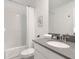 A modern bathroom features a sleek vanity with a gray countertop, a stylish mirror, and a shower with curtains at 9118 Sommerset Hills Dr, Davenport, FL 33896