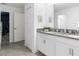 Bathroom featuring a double vanity, white cabinets, and modern fixtures, with access to hall at 9118 Sommerset Hills Dr, Davenport, FL 33896