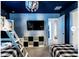 Unique bedroom featuring a bunk bed, decorative lighting, and a TV at 9118 Sommerset Hills Dr, Davenport, FL 33896