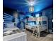 Themed bedroom featuring bunk beds, a standard bed, and custom wall decor at 9118 Sommerset Hills Dr, Davenport, FL 33896