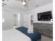 Bright bedroom with a ceiling fan, large TV, and ample storage space at 9118 Sommerset Hills Dr, Davenport, FL 33896