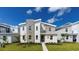 Modern two-story home featuring stone accents, a manicured lawn, and a bright, inviting entrance at 9118 Sommerset Hills Dr, Davenport, FL 33896