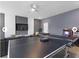 Spacious game room with ping pong table, arcade games, and entertainment setup at 9118 Sommerset Hills Dr, Davenport, FL 33896