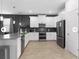 Modern kitchen featuring white cabinets, a breakfast bar with seating, and stainless steel appliances at 9118 Sommerset Hills Dr, Davenport, FL 33896