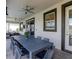 Covered patio with ceiling fans, and plenty of seating, including a large table for outdoor entertaining at 9118 Sommerset Hills Dr, Davenport, FL 33896