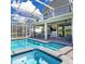 A sparkling pool features an attached spa and spacious seating areas for relaxing and entertaining outdoors at 9118 Sommerset Hills Dr, Davenport, FL 33896