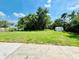 A spacious backyard featuring a lush green lawn, mature trees, and a shed for extra storage at 467 Martigues Drive, Kissimmee, FL 34759