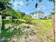 A spacious backyard featuring a lush green lawn, mature trees, and a shed for extra storage at 467 Martigues Drive, Kissimmee, FL 34759