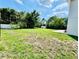 A spacious backyard featuring a lush green lawn, mature trees, and a shed for extra storage at 467 Martigues Drive, Kissimmee, FL 34759