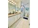 Bright bathroom with double sinks, granite countertops, and a glass-enclosed shower for a luxurious feel at 467 Martigues Drive, Kissimmee, FL 34759