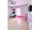 Bedroom with a desk, and play area, featuring neutral tones and a ceiling fan at 467 Martigues Drive, Kissimmee, FL 34759