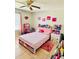 Charming bedroom with a pink bed, tiled floors, and cheerful decor creates a playful space at 467 Martigues Drive, Kissimmee, FL 34759