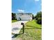 Charming two-story home with a well-manicured lawn and a two-car garage, located on a sunny street at 467 Martigues Drive, Kissimmee, FL 34759