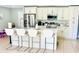 Bright, updated kitchen featuring white cabinets, stainless steel appliances, and an island with barstool seating at 467 Martigues Drive, Kissimmee, FL 34759