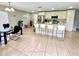 Spacious kitchen boasts a large island with seating and stainless appliances, seamlessly integrated into the dining area at 467 Martigues Drive, Kissimmee, FL 34759