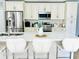 Bright kitchen with white cabinets, stainless steel appliances, and a large island with seating at 467 Martigues Drive, Kissimmee, FL 34759
