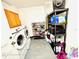 Laundry room with washer/dryer, overhead storage, and shoe shelves for organization at 467 Martigues Drive, Kissimmee, FL 34759