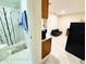 Spacious living area featuring a kitchenette, black futon, and laminate floors at 467 Martigues Drive, Kissimmee, FL 34759